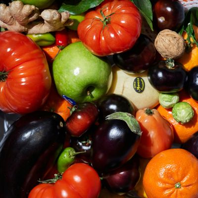 Vitamin Complex A diverse assortment of fruits and vegetables rich in vitamins, including apples, oranges, tomatoes, peppers, and broccoli